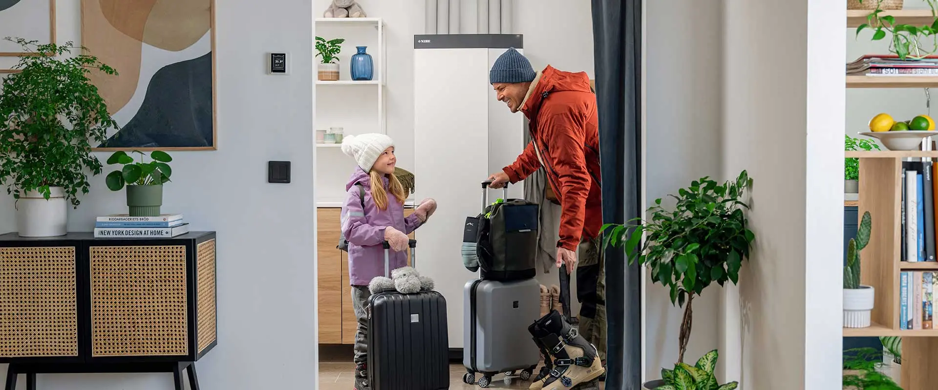 Daughter and dad in front of heat pump