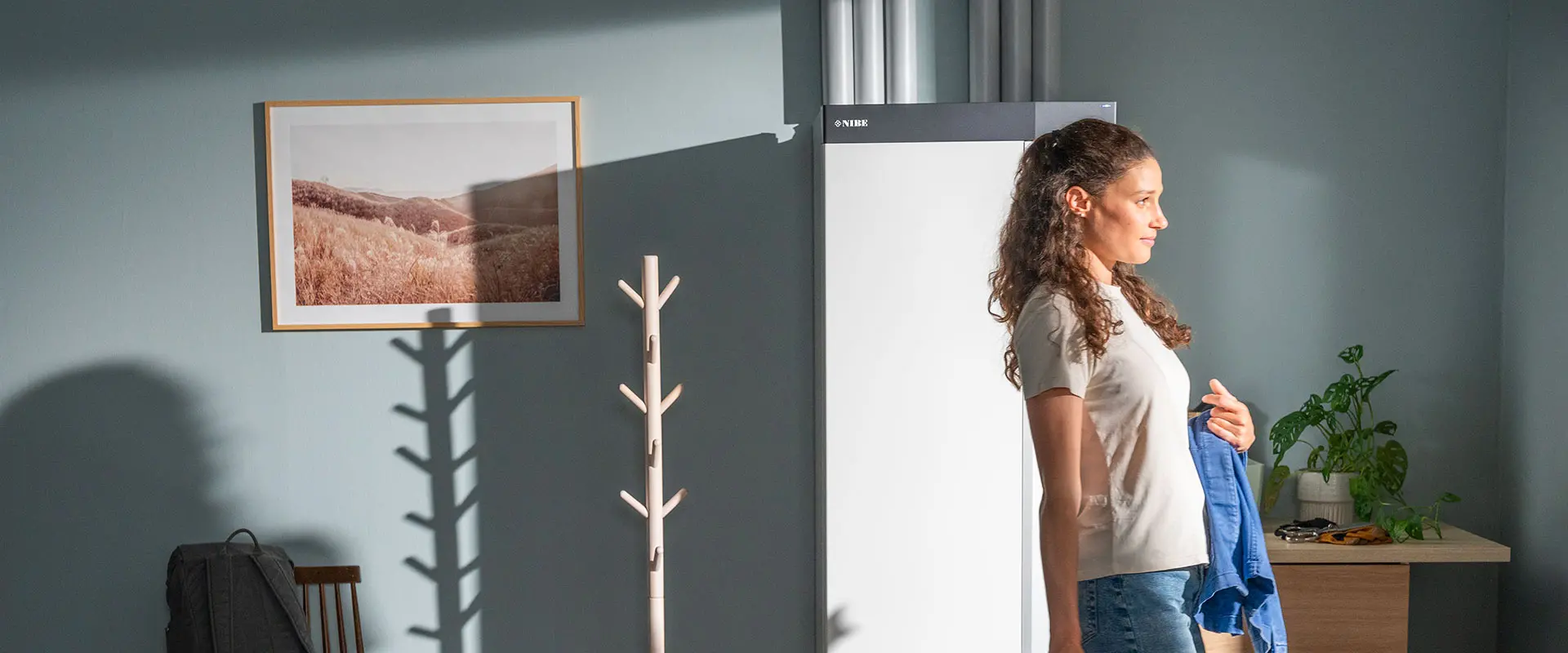 Woman walking next to a heat pump