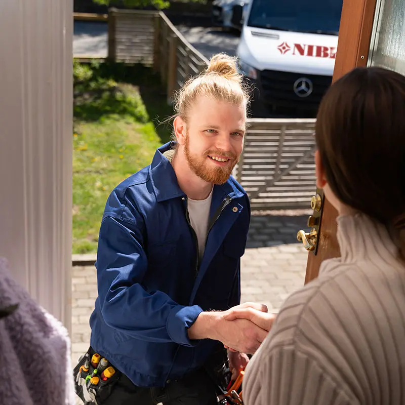 Installer shaking homeowners hand