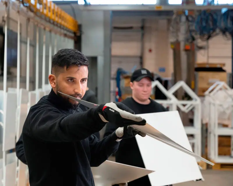 Man holding a metal sheet