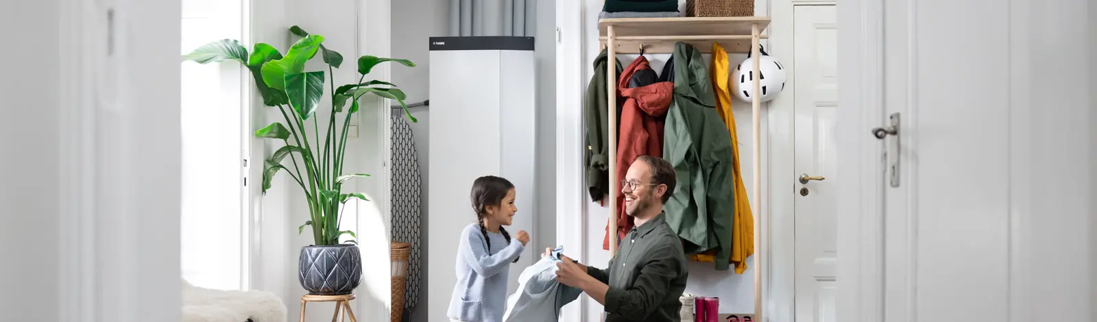 Father and Child Infront of a Heat Pump