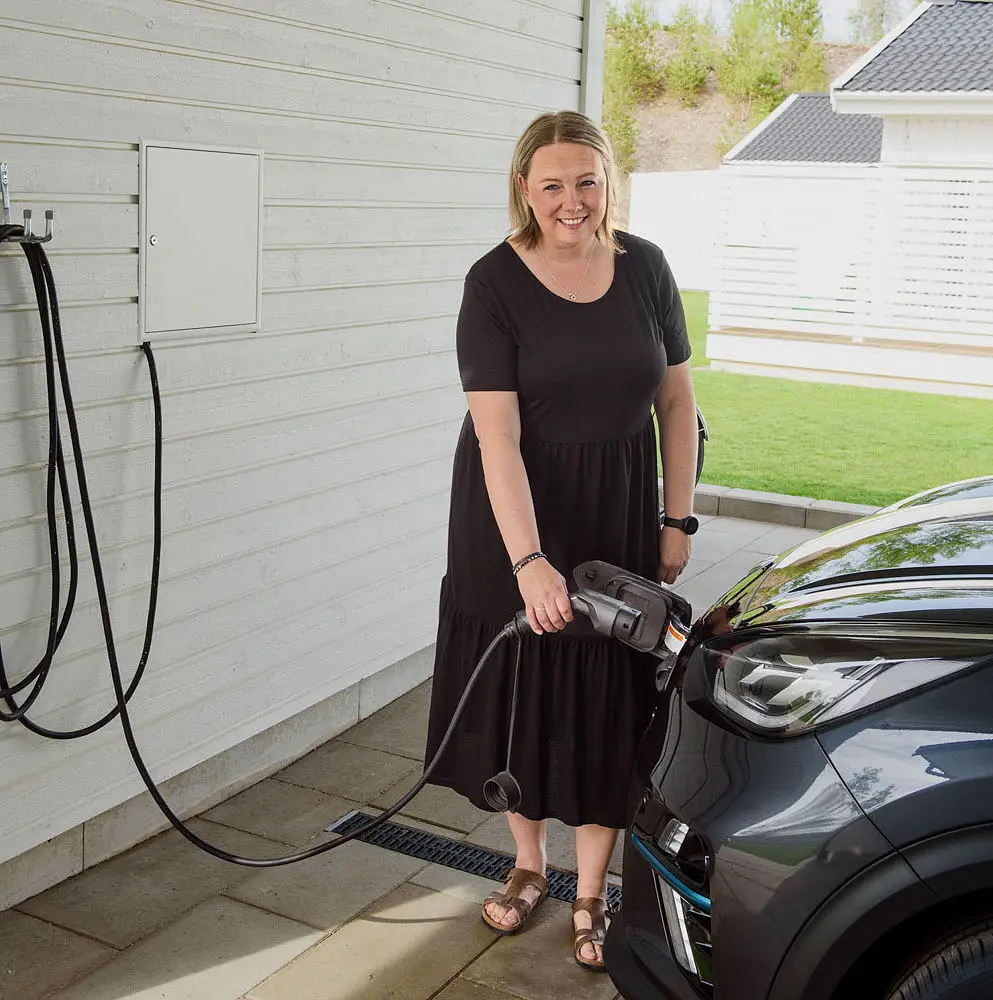 Therese standing besides the car