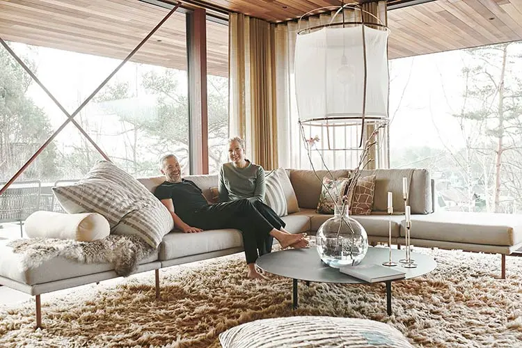 man and women sitting in a sofa in there livingroom